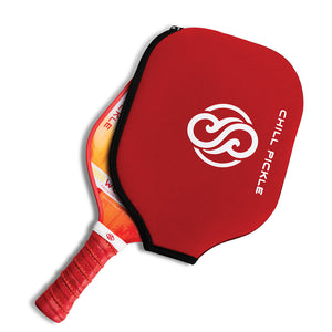 Red Chill Pickle pickleball paddle cover fitted over a paddle head in studio lighting