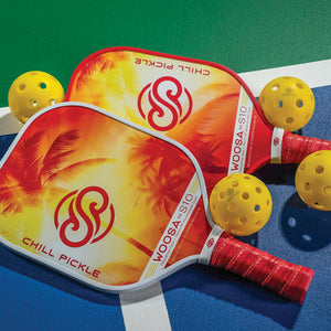 Two Chill Pickle Woosa pickleball paddles on a court with yellow outdoor balls