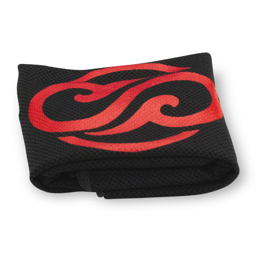 Folded black and red Chill Pickle cooling towel with tropical swirl logo