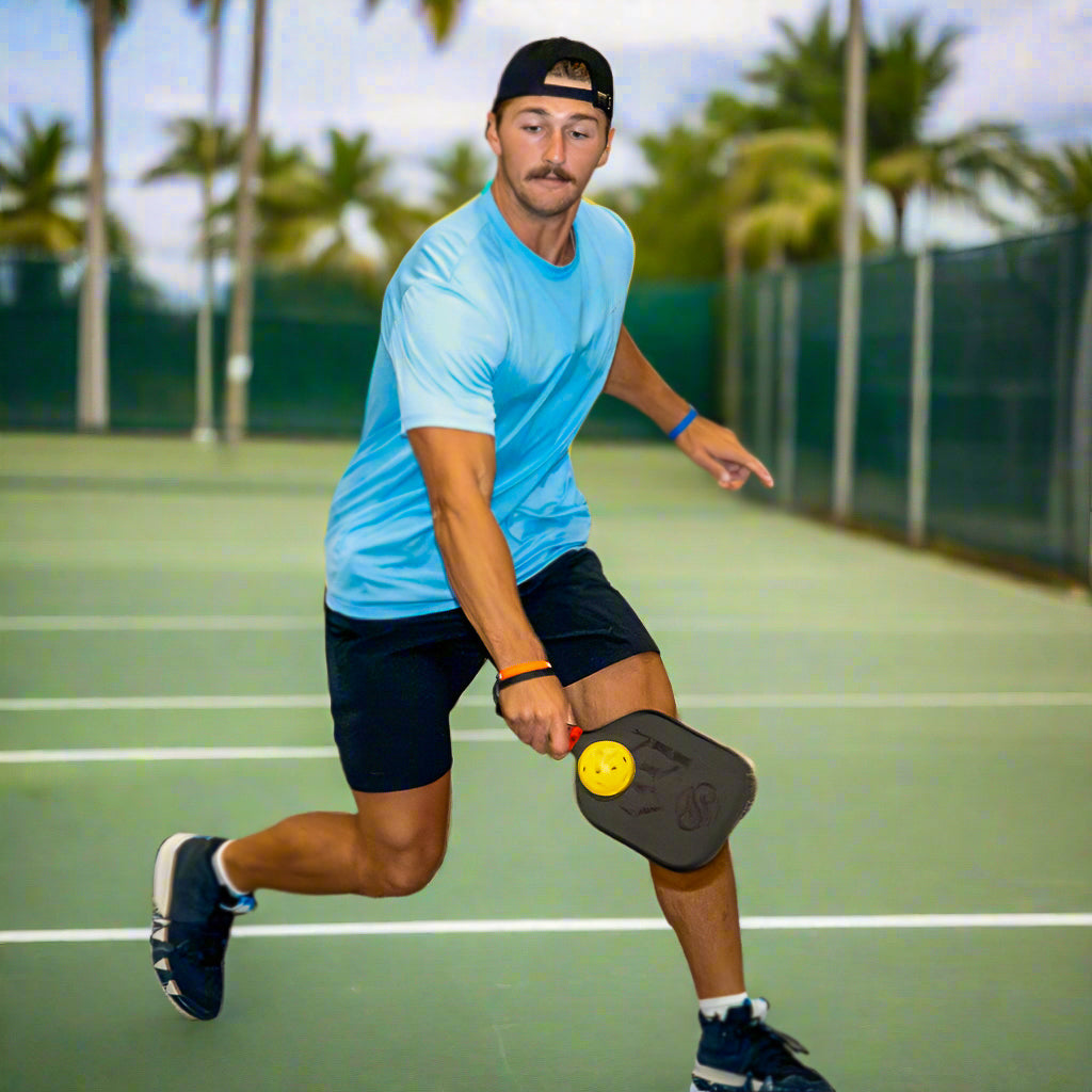 Pickleball player running across the court with a Chill Pickle Kahuna paddle during match play