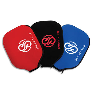 Three Chill Pickle pickleball paddle covers shown together in red, black, and blue color options