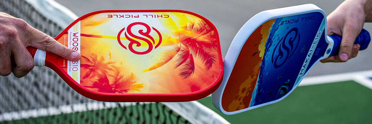 Two colorful pickleball paddles stretching across a tropical-styled action banner
